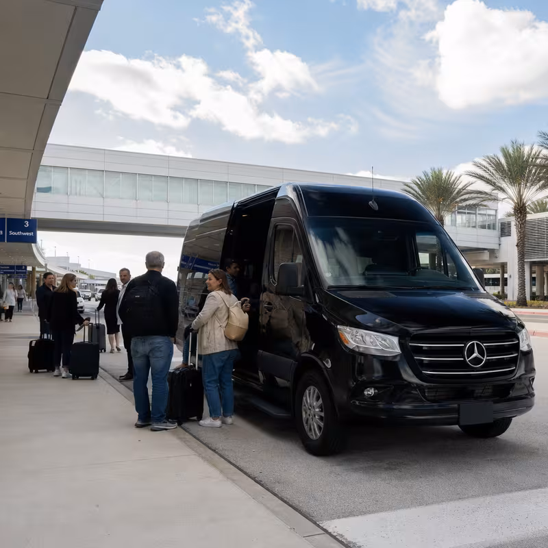 Group boarding a white charter bus for Airport Transportation transportation in Orlando
