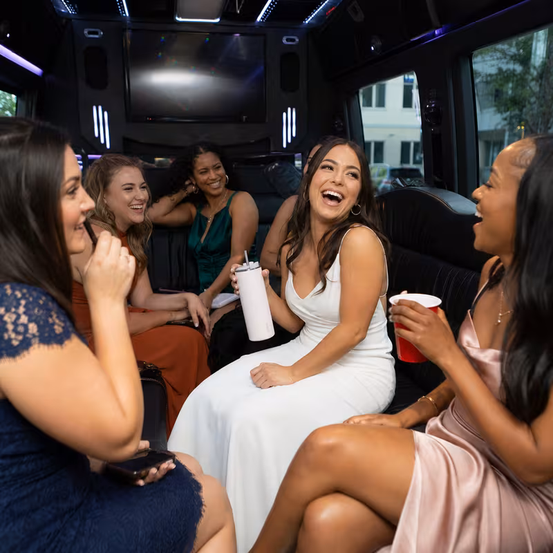 Party bus interior with wraparound leather seating and LED lighting in Orlando