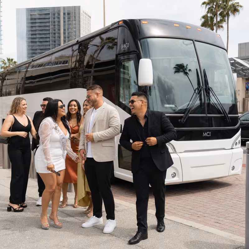 Passengers loading luggage while boarding an Orlando group shuttle