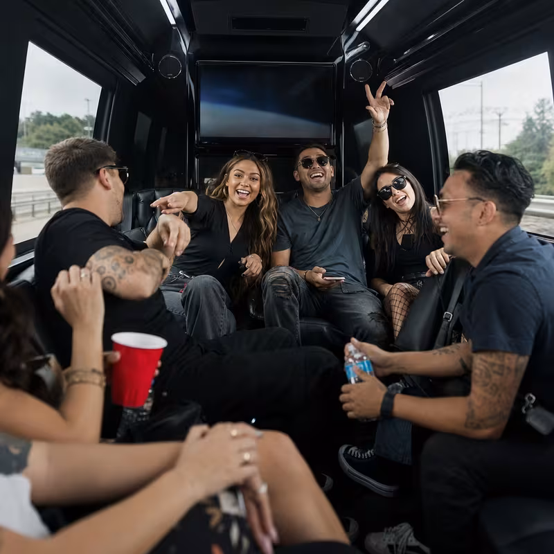 Group boarding a white charter bus for Concert Transportation transportation in Orlando