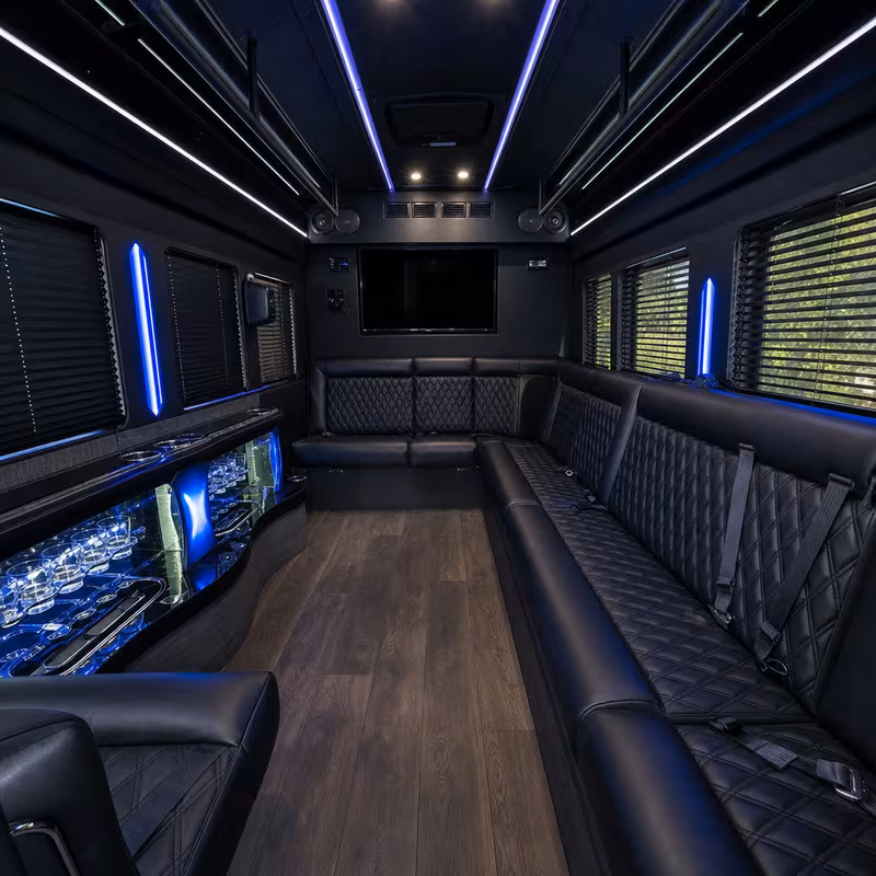 Party bus interior with wraparound leather seating and LED lighting in Orlando