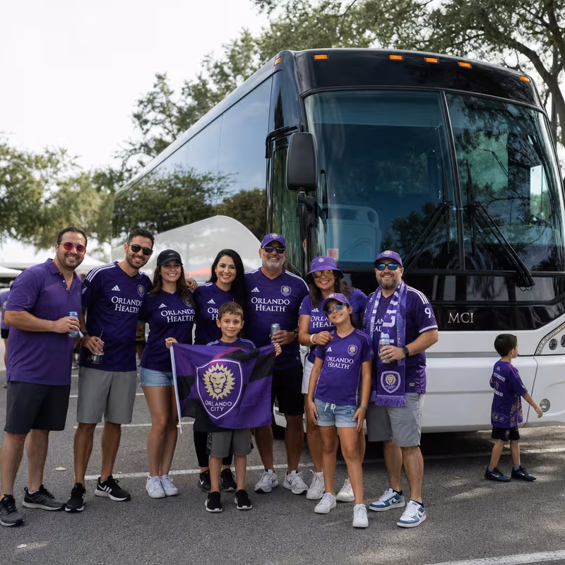 Passengers loading luggage while boarding an Orlando group shuttle
