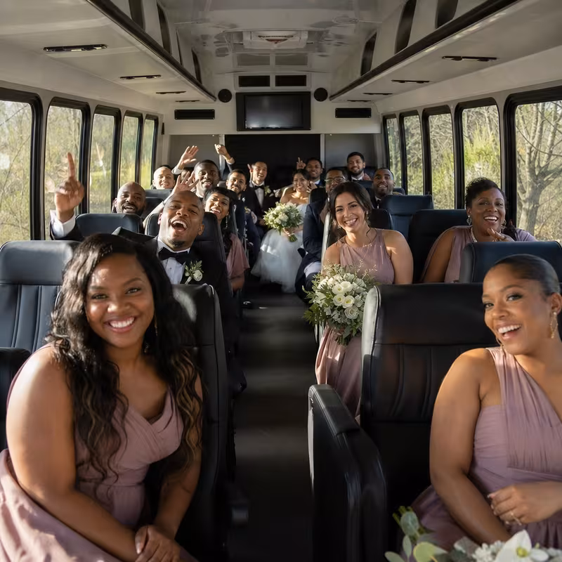 Group boarding a white charter bus for Wedding Transportation transportation in Orlando