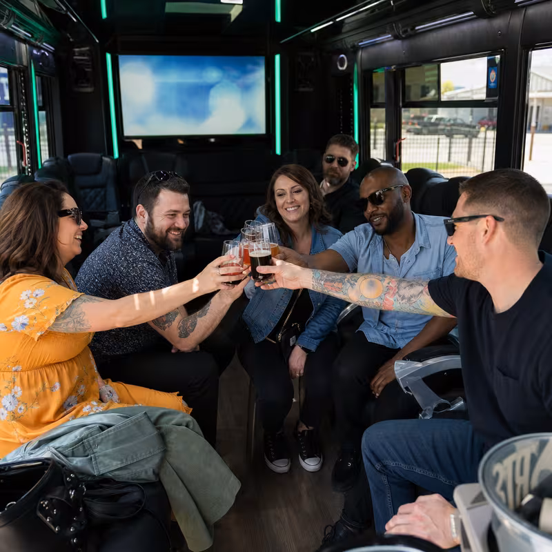 Group boarding a white charter bus for Winery & Brewery Tour Transportation transportation in Orlando