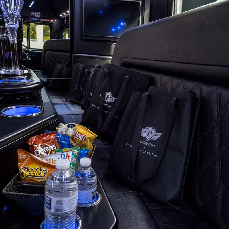 Party bus interior with wraparound leather seating and LED lighting in Orlando